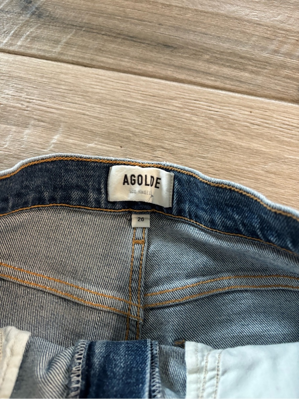 Agolde High-Rise Jeans in Medium Blue Denim with Gold Stitching